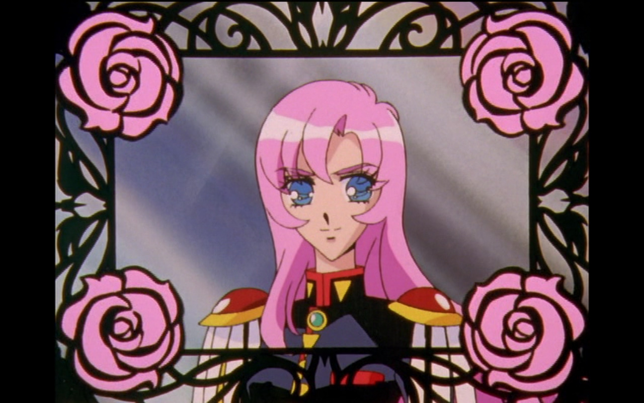 A screencap from Revolutionary Girl Utena, an anime. It is a profile shot of Utena from the chest up, she is a teenage girl with long pink hair, dressed in a black and red sailor-style Japanese BOYS school uniform, with red epaulets on the shoulders that have dangling white tassles. The whole shot is framed as if it were a painting by a frame that looks as if it's made of wrought-iron rose stems, with pink roses in each of the four corners.