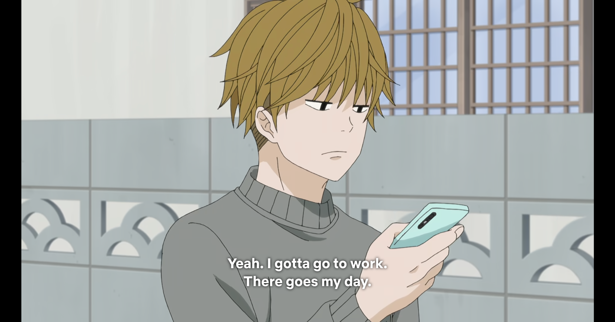 Karino, a young man with messy dirty blonde hair wearing a grey sweatshirt, is looking at his phone while walking. The caption reads “Yeah. I gotta go to work. There goes my day”