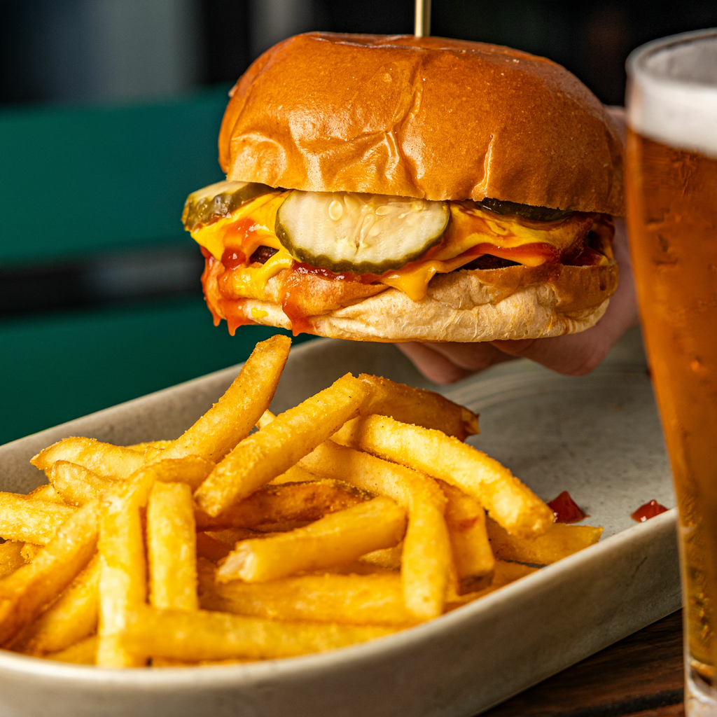 A professional photo of the cheeseburger showcasing the pickles, sauce, and american cheese. Apologies for no shot of my own, I forgot to take the photo before I ate.