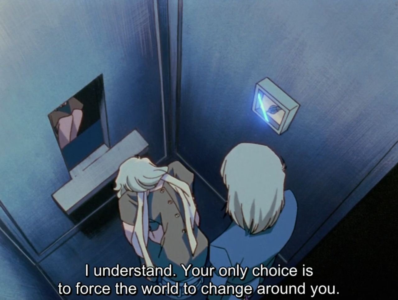 An overhead view of Kanae and Mikage standing together in the dim, cramped elevator, facing a wall with a small glowing panel. The subtitle reads “I understand. Your only choice is to force the world to change around you.”