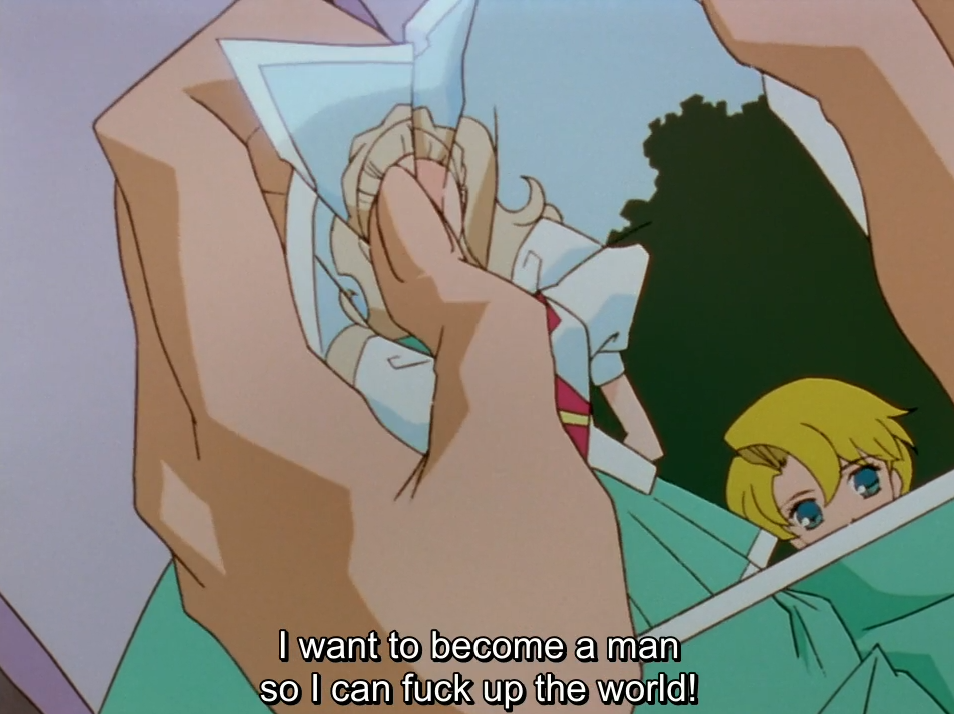 A close-up of a hand crumpling a photo of a blonde girl in a school uniform, while Mitsuru’s face peeks in from the corner of the frame. The subtitle reads “I want to become a man so I can fuck up the world!”