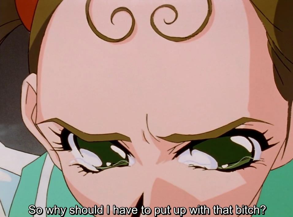 An extreme close-up of Keiko’s face from the nose up, with curled bangs, furrowed brows and tearful green eyes. The subtitle reads “So why should I have to put up with that bitch?”