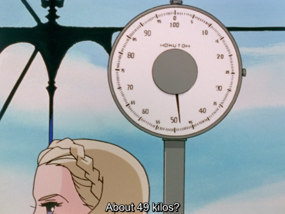 A large dial scale marked “HOKUTOH” with its needle just under 50, against a blue sky, with the top of a blonde girl’s braided head in the corner. The subtitle reads “About 49 kilos?”