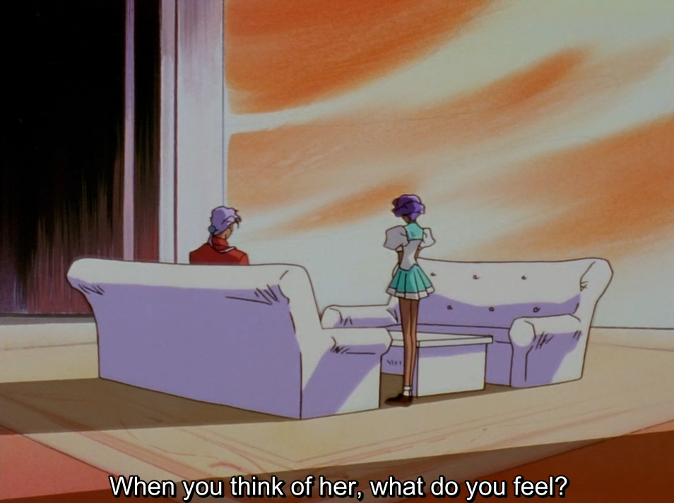 Akio, seen from behind on a white sofa, and Anthy standing near him in a large room lit by an orange sky. The subtitle reads "When you think of her, what do you feel?"