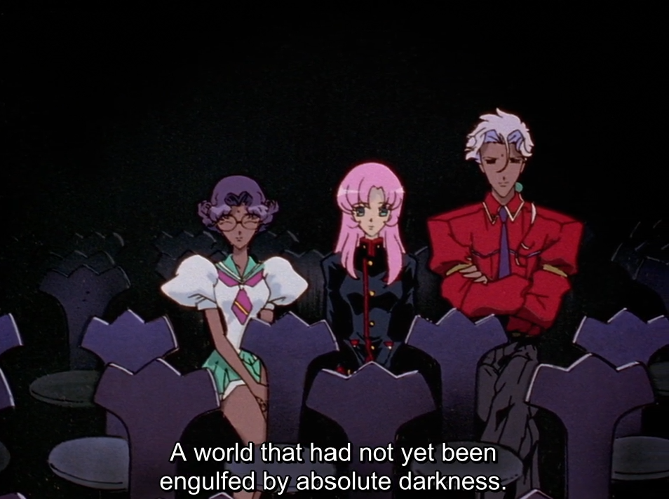 Anthy, Utena and Akio sit side by side in a dark auditorium among rows of purple seats, watching a performance; Akio has his arms crossed. The subtitle reads “A world that had not yet been engulfed by absolute darkness.”