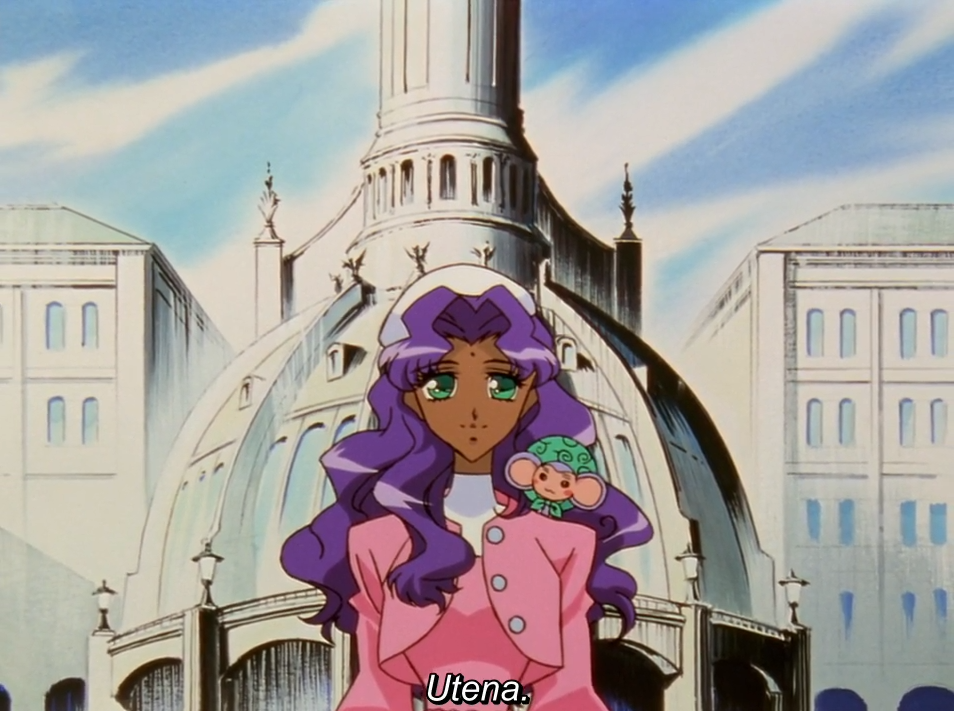 Anthy, in a pink jacket with her long purple hair down and Chu-Chu on her shoulder, stands in front of a domed academy building under a blue sky. The subtitle reads “Utena.”